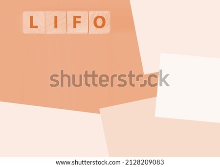 LIFO Last in, first out word on wooden cubes on blue background. Accounting, Business Concept image.