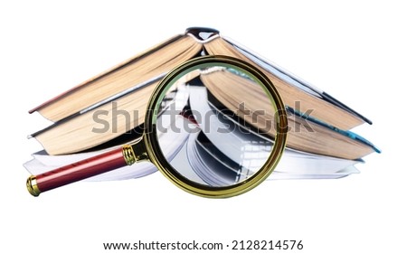 Abstract books through magnifying glass isolated on white background. High quality photo