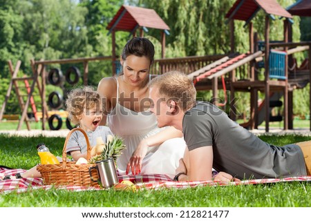 Family picnic on the playground during sunny day