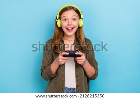 Photo of funky positive crazy cheerful little lady game addicted causal wear teenager isolated on blue color background