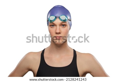 Swimmer female wearing swimming hat and goggles. Headshot studio portrait isolated against white background