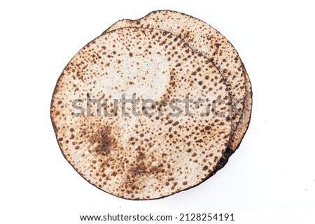 Matzah Shmurah. Jewish traditional Passover bread. Pesach celebration symbol. Close-up Royalty-Free Stock Photo #2128254191