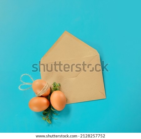 easter eggs with greenery in an envelope, copy space for text, promo or message. easter greeting or sale concept. High quality photo