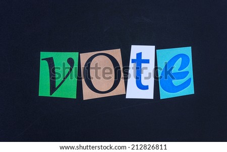 The word vote in cut out magazine letters on blackboard
