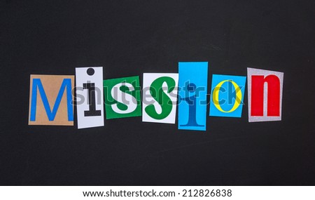 The word mission in cut out magazine letters on blackboard