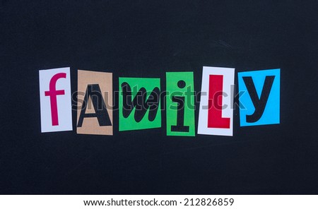 The word family in cut out magazine letters on blackboard