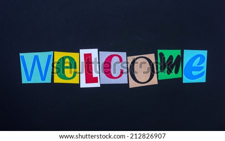 The word welcome in cut out magazine letters on blackboard