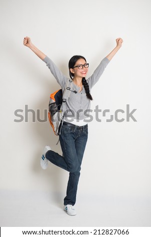 asian college girl celebrating success in joy