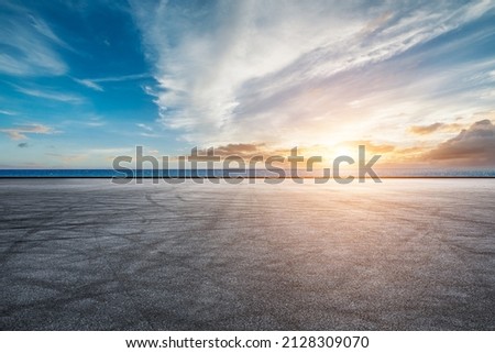 Empty asphalt road and sea natural scenery at sunrise Royalty-Free Stock Photo #2128309070