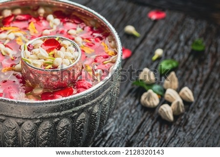 Roses, jasmine and marigolds In a large silver bowl on a wooden floor , Songkran Festival or Thai New Year Royalty-Free Stock Photo #2128320143