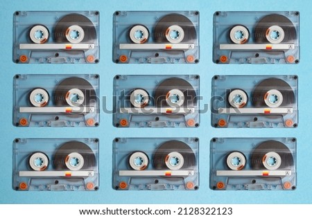 Copy pasted audio cassettes on blue background , directly above , top view 