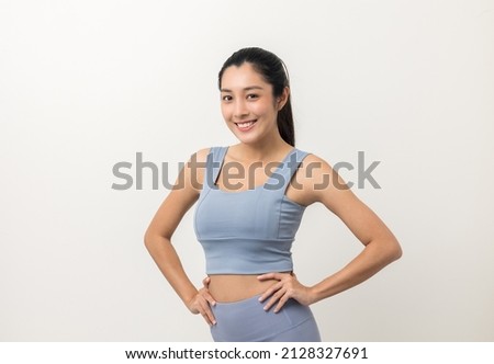 Young beautiful asian woman with sportswear on isolated white background. Portrait sporty woman standing pose exercise workout in studio. Royalty-Free Stock Photo #2128327691