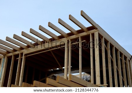 Extension of a family house, cubic shape modern with a flat roof and large windows and a terrace. wooden frame on which will be insulation and cladding. ecological renewable houses Royalty-Free Stock Photo #2128344776