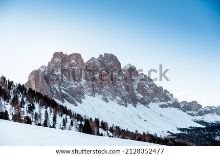 A chilling view of the snow-capped mountain and forest landscape in South Tyrol, Italy
