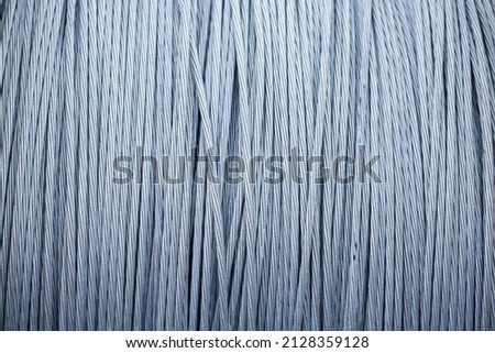 large coil of steel cable, steel braided cable is wound into a roll. Royalty-Free Stock Photo #2128359128