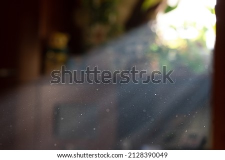 Sun spells by window with bright stream of light and visible particles indoors in room isolated. Clean room and dust in air concept Royalty-Free Stock Photo #2128390049