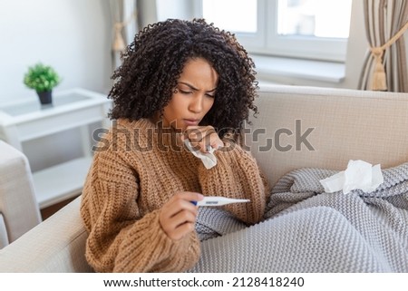 Sick day at home. Young woman has runny and common cold. Cough. Closeup Of Beautiful Young Woman Caught Cold Or Flu Illness. Portrait Of Unhealthy woman with coronavirus, covid19 symptoms Royalty-Free Stock Photo #2128418240
