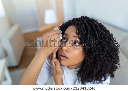 Woman using eye drop, woman dropping eye lubricant to treat dry eye or allergy, sick woman treating eyeball irritation or inflammation woman suffering from irritated eye, optical symptoms Royalty-Free Stock Photo #2128418246