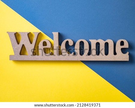 Welcome board on yellow and blue background