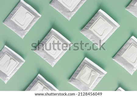 Drip coffee bags with ground coffee for brewing in cup, package with paper bag drip coffee filter on mint color background, top view, minimal flat lay, geometric pattern, pastel colors Royalty-Free Stock Photo #2128456049