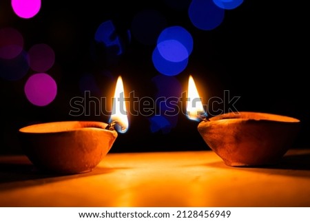Clay oil lamps or diyas lit on Diwali Royalty-Free Stock Photo #2128456949