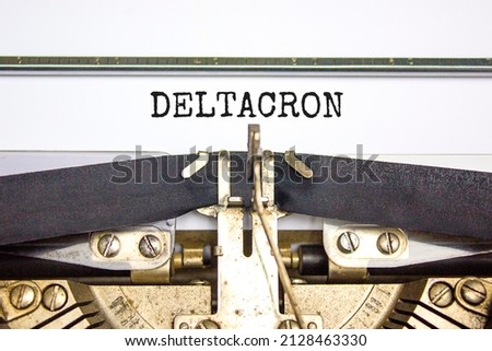 Covid-19 corona deltacron symbol. The concept word Deltacron typed on retro typewriter. Beautiful white background. Medical, covid-19 corona deltacron variant concept. Copy space.