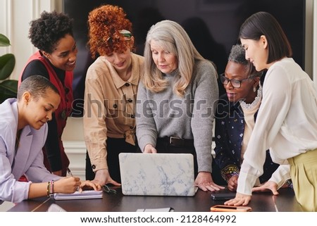 Multi ethnic mixed age range women in creative business meeting Royalty-Free Stock Photo #2128464992