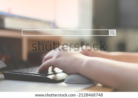 Close up of human hand typing on computer keyboard as background of search engine browser