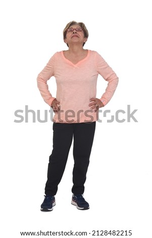 full portrait of happy woman with sportswear looking up on white background