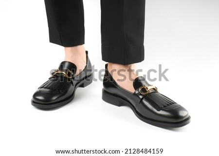 Loafers isolated on white background. Pair of Stylish Expensive Modern Leather Black Loafers Shoes. Fashion concept with woman shoes on white. Royalty-Free Stock Photo #2128484159
