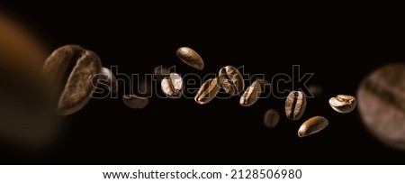 Coffee beans in flight on a dark background Royalty-Free Stock Photo #2128506980