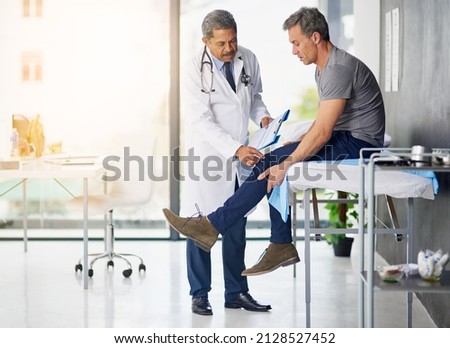 Doctors do it for the health of it. Shot of a mature doctor examining his patient who is concerned about his knee. Royalty-Free Stock Photo #2128527452