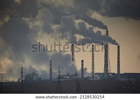 The plant emits smoke and smog from the pipes at mist cloudy, pollutants enter the atmosphere. Environmental disaster. Harmful emissions into. Exhaust gases. Chemical industry against the sky. Royalty-Free Stock Photo #2128530254