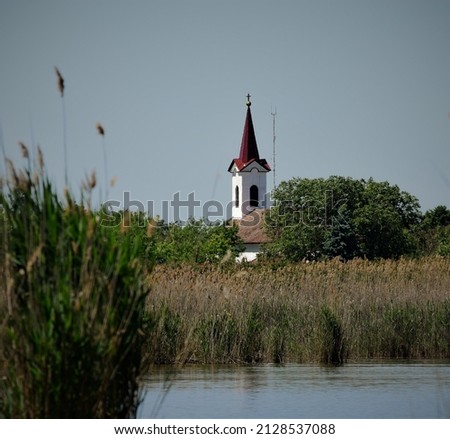 Lake Ludas with a church in the background near Subotica in Serbia