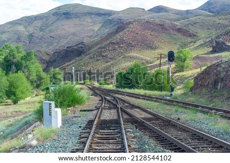 railway, railroad, rail, elevated. steppe.- is a means of transportation and passengers of trucks moving on rails that are located on the rails of the Great Plains. Kazakhstan The steppe is great. Royalty-Free Stock Photo #2128544102