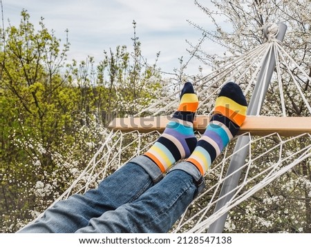 Men's legs and bright socks. Close-up, outdoor. Style, beauty and elegance concept