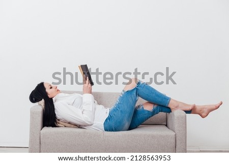 brunette woman on a gray sofa house