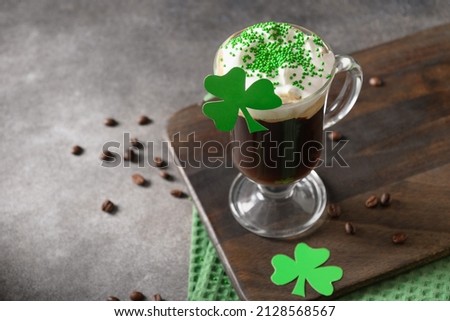 Patrick's Day and celebration with Irish coffee in glass cup with green sprinkles on gray background. Close up. Copy space. Royalty-Free Stock Photo #2128568567