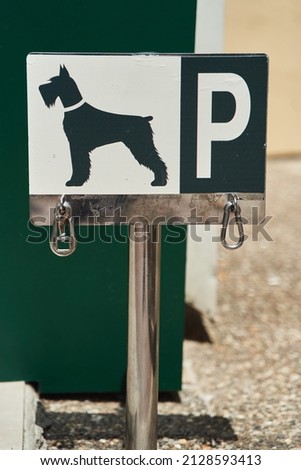 Designated dog parking sign. Place for bind dogs waiting for owners outside, with rings for attaching leash, on public place area or shop. 