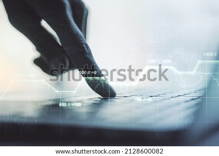 Multi exposure of creative statistics data hologram with hands typing on computer keyboard on background, stats and analytics concept