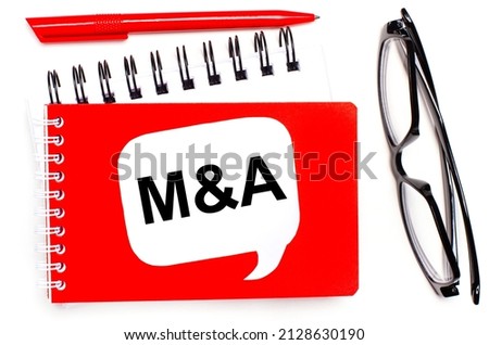 On a white background, white and red notepads, black glasses, a red pen and a white card with the text M AND A