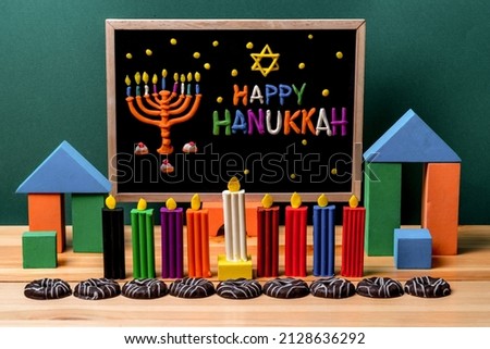 Hanukkiah and Happy Hanukkah inscription made of plasticine