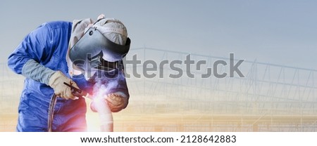 banner of worker welding metal steel pipe by TIG torch innert gas wearing safety mask and suit is welding metal panorama image construction steel with copy space
 Royalty-Free Stock Photo #2128642883