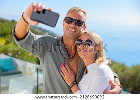 Couple taking selfie picture with mobile phone