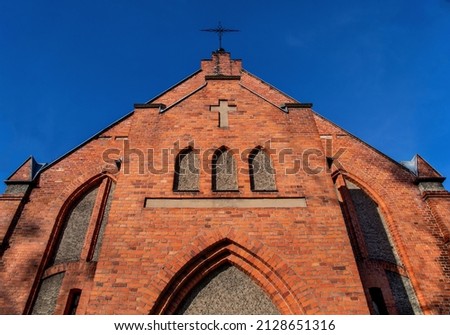 Built in 1904 in the neo-Gothic style, the Church of Christians the Baptists in the city of Sczytno in Masuria, Poland. Since 1994, the temple is on the register of monuments. Royalty-Free Stock Photo #2128651316