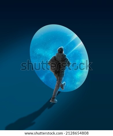 Conceptual creative artwork with young man walking on outer space background. Concept of astronautics, dreams, astronomy, art, Day of Human Space Flight. Contemporary art collage. Ideas, imagination Royalty-Free Stock Photo #2128654808