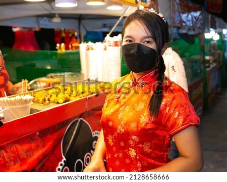 Asian woman wear red cheongsam dress. Chinese new year celebration concept.
