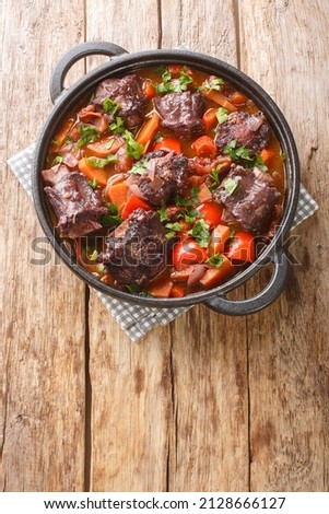 Spanish Bull Tail Stew Rabo De Toro closeup on a pot on the wooden table. Vertical top view from above
 Royalty-Free Stock Photo #2128666127