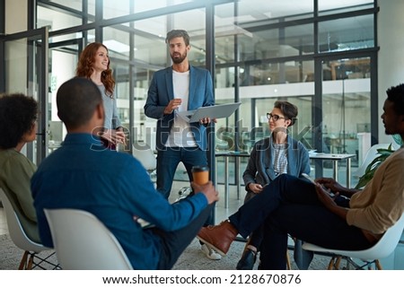 Working towards maximising their potential as a team. Cropped shot of a group of creatives having a meeting in a modern office. Royalty-Free Stock Photo #2128670876