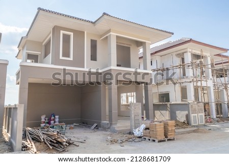 construction residential new house in progress at building site housing estate development Royalty-Free Stock Photo #2128681709